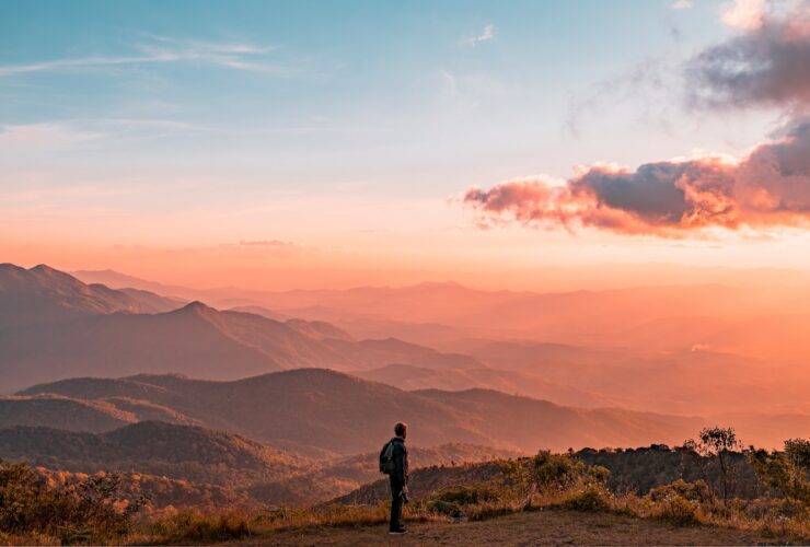 man standing on hill digital wallpaper